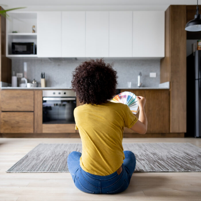 women in kitchen looking at paint samples